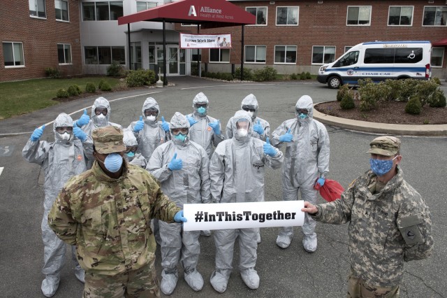 Soldiers and Airmen from the Massachusetts National Guard gather together prior to completing COVID-19 testing on residents at the Alliance at West Acres nursing home, Brockton, Mass., April 10, 2020. Twelve medical teams are activated throughout the state and are conducting COVID-19 testing at medical facilities and nursing homes with high-risk populations. Homes and providers are identified by the Department of Public Health and Human Services for testing. This mission is one of several operations across the commonwealth in support of coronavirus response efforts. (Capt. Bonnie Blakely)