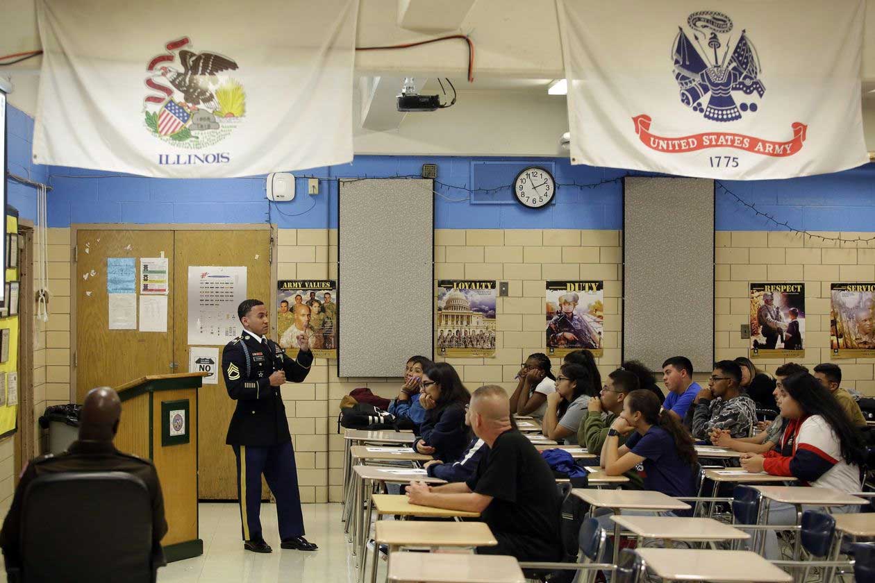 Sgt. 1st Class Jose Tejada speaks to a class of Junior ROTC students about what life is like in the U.S. Army for new recruits. PHOTO: JOSHUA LOTT FOR THE WALL STREET JOURNAL