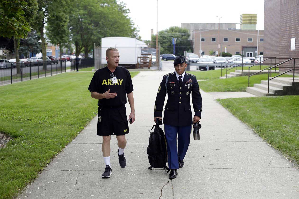 A senior Army instructor, Harry Mercado, speaks with Sgt. Tejada ahead of a visit to the Prosser Career Academy in Chicago earlier this month. PHOTO: JOSHUA LOTT FOR THE WALL STREET JOURNAL