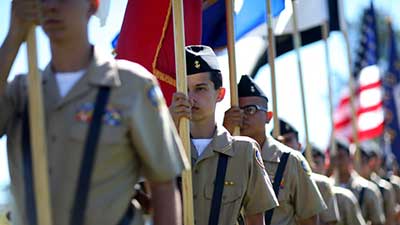 A Joint JROTC Honor Guard prepares to post the colors